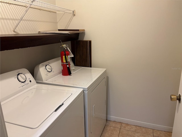 washroom featuring light tile patterned floors and washing machine and dryer