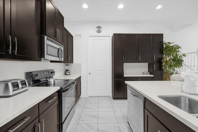 kitchen with dark brown cabinetry and stainless steel appliances