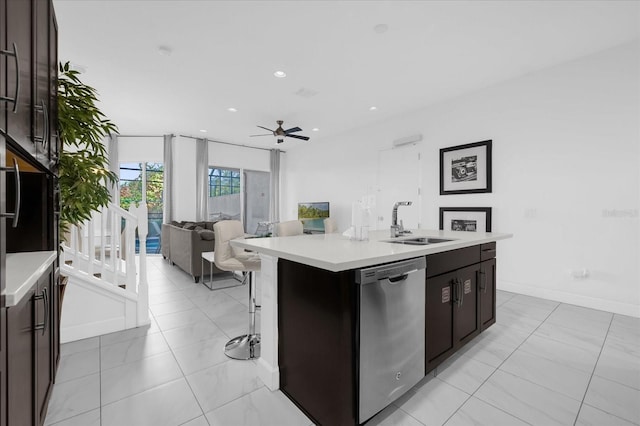 kitchen featuring sink, stainless steel dishwasher, ceiling fan, an island with sink, and dark brown cabinets