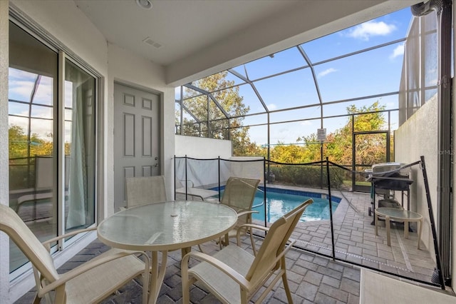 sunroom featuring a pool and a healthy amount of sunlight