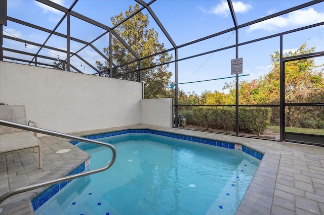 view of swimming pool featuring a patio and a lanai