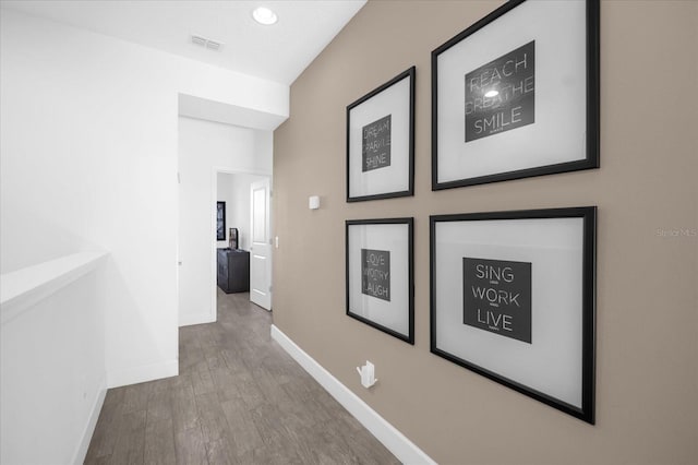 corridor with hardwood / wood-style floors