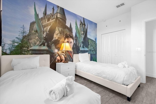 bedroom featuring a closet and dark hardwood / wood-style floors