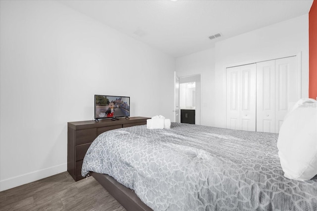 bedroom with hardwood / wood-style flooring and a closet