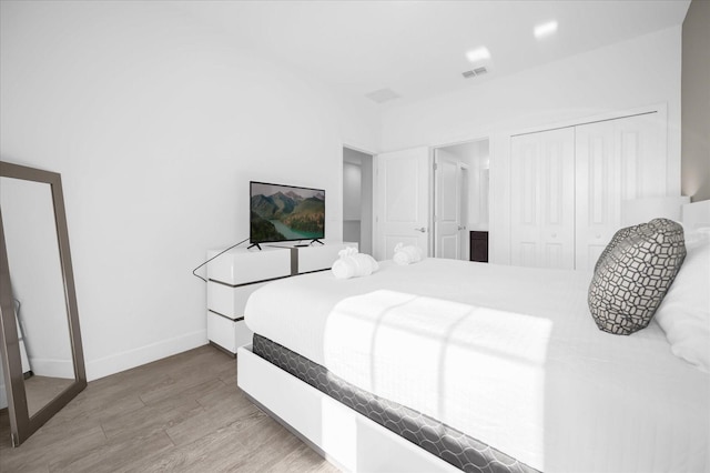 bedroom featuring hardwood / wood-style floors and a closet