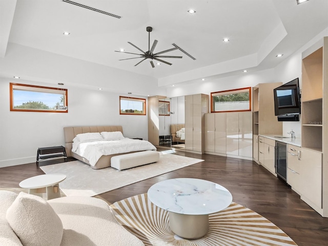 bedroom featuring dark hardwood / wood-style floors, wine cooler, multiple windows, and sink