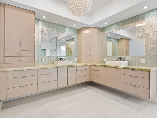 bathroom with decorative backsplash, walk in shower, vanity, and a chandelier