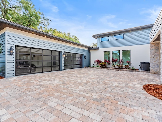 view of patio / terrace featuring a garage and central AC