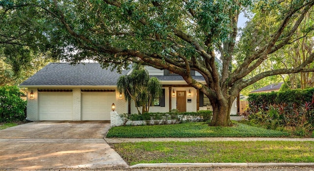 view of front of home with a front yard and a garage