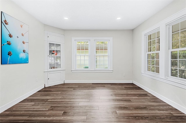 unfurnished dining area with dark hardwood / wood-style flooring