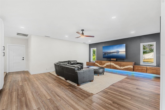 living room featuring ceiling fan and light wood-type flooring