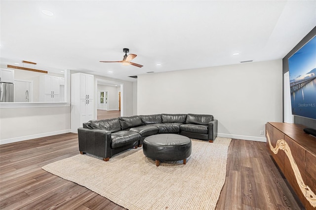 living room with ceiling fan, sink, and hardwood / wood-style flooring