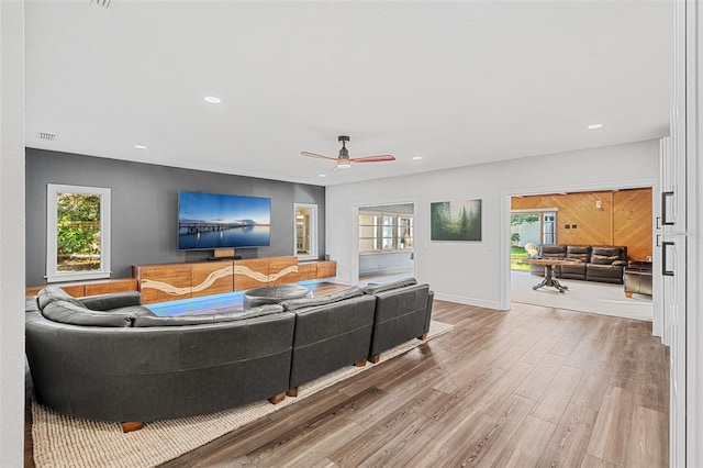 living room featuring hardwood / wood-style flooring and ceiling fan