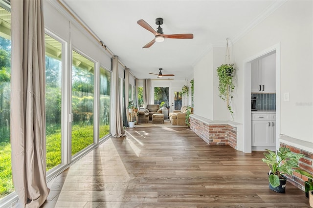 sunroom / solarium featuring ceiling fan