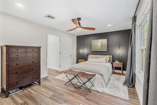 bedroom with ceiling fan and light hardwood / wood-style floors