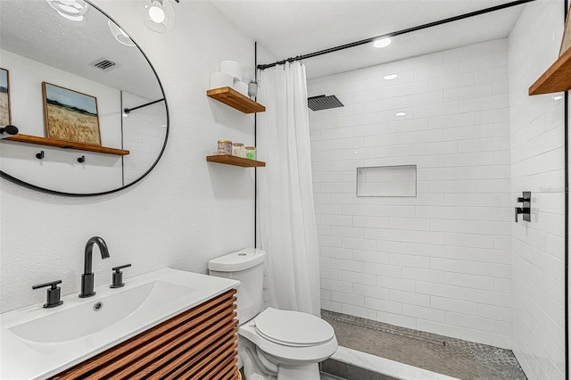 bathroom with vanity, a shower with shower curtain, and toilet