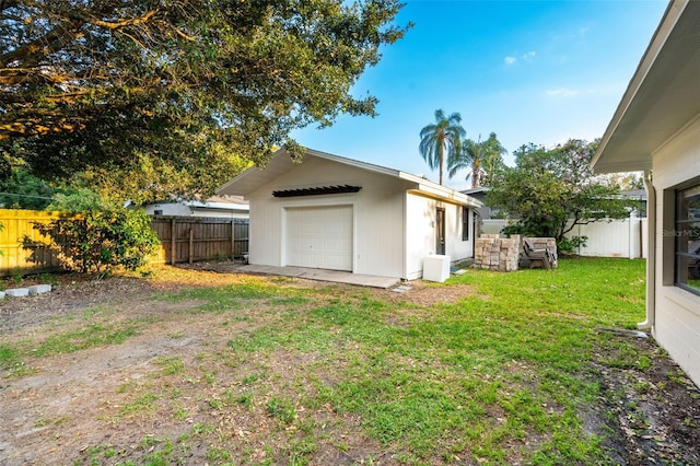 view of side of home with a yard, an outbuilding, and a garage