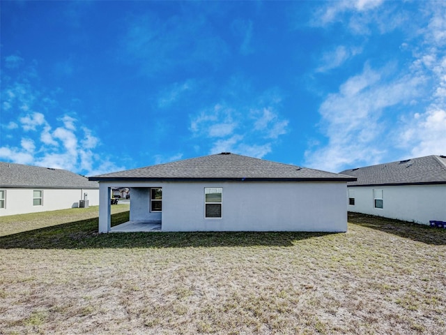 rear view of house featuring a patio and a lawn