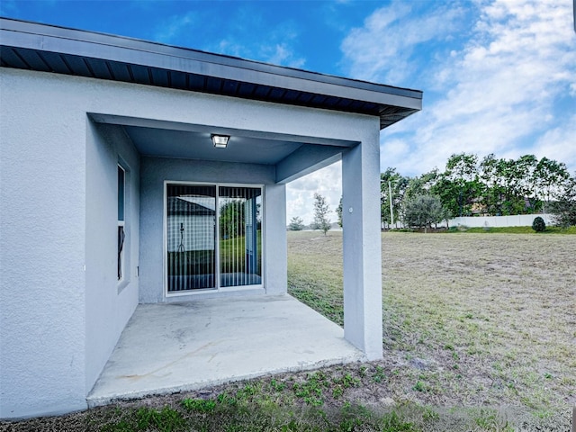 view of exterior entry featuring a patio