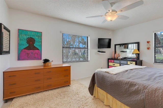 bedroom featuring ceiling fan and a textured ceiling