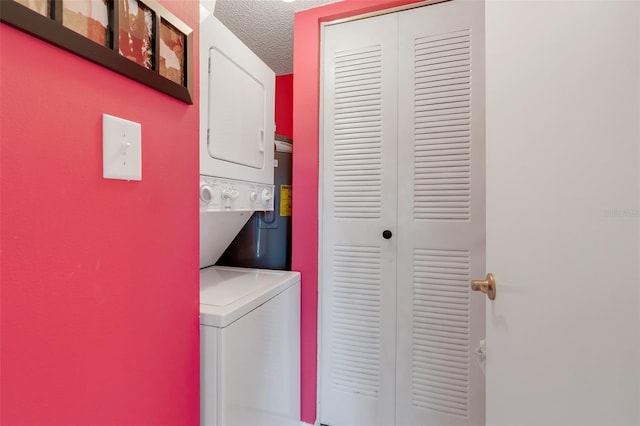 laundry room featuring stacked washer and dryer and a textured ceiling