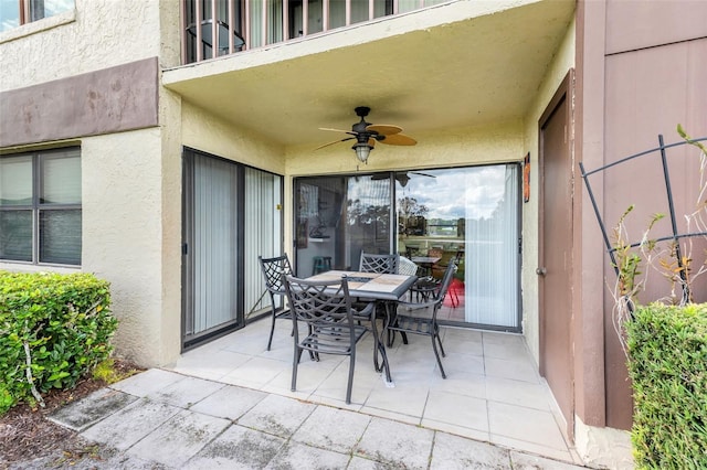 view of patio featuring ceiling fan and a balcony