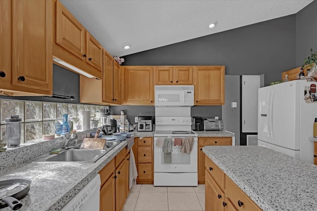 kitchen featuring light stone countertops, white appliances, sink, lofted ceiling, and light tile patterned flooring