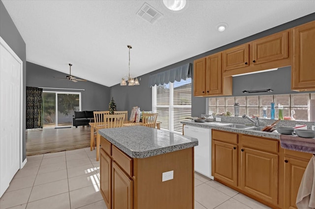 kitchen with ceiling fan with notable chandelier, decorative light fixtures, dishwasher, a center island, and lofted ceiling