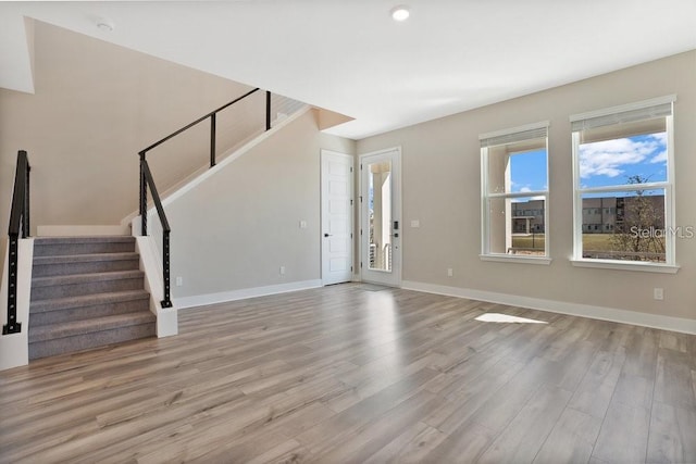 unfurnished living room featuring light wood-type flooring