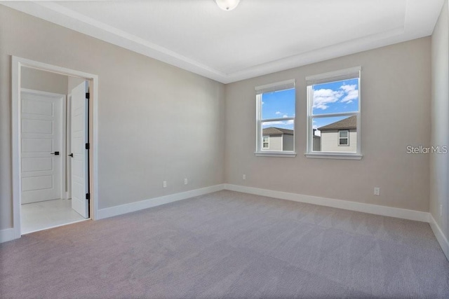 spare room featuring light carpet