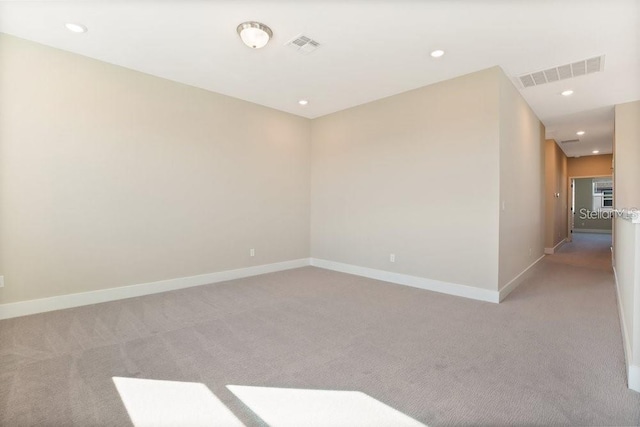 spare room with light colored carpet