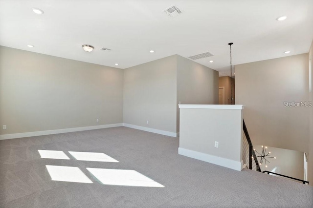 unfurnished room featuring light colored carpet