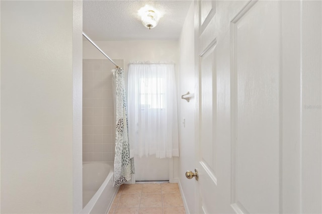 bathroom featuring tile patterned flooring, a textured ceiling, and shower / bathtub combination with curtain