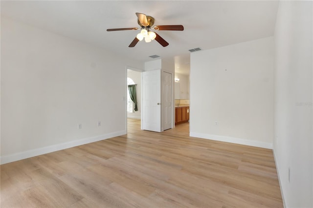 spare room featuring light hardwood / wood-style flooring and ceiling fan