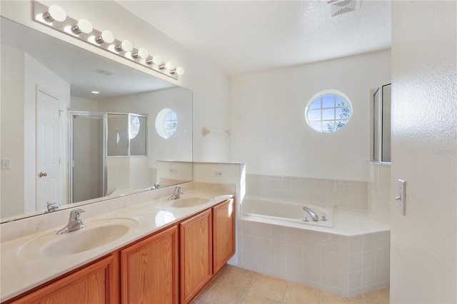 bathroom with vanity, tile patterned floors, and separate shower and tub