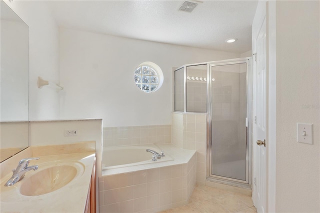 bathroom featuring tile patterned flooring, vanity, shower with separate bathtub, and a textured ceiling