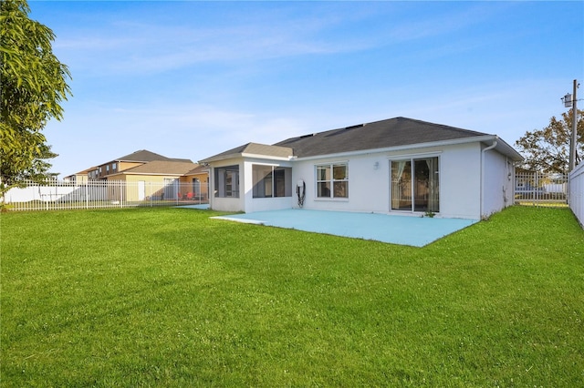 back of property featuring a patio, a sunroom, and a lawn