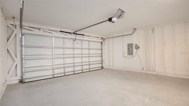 garage with electric panel and a garage door opener