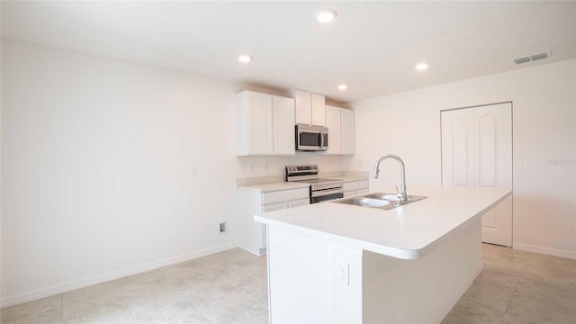532 Piedmont St, Lehigh Acres, FL 33974 - kitchen with appliances with stainless steel finishes, an island with sink, light countertops, white cabinetry, and recessed lighting