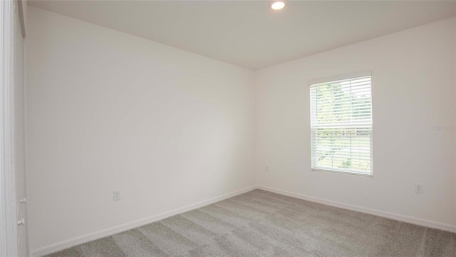 532 Piedmont St, Lehigh Acres, FL 33974 - spare room with healthy amount of natural light, light colored carpet, and recessed lighting
