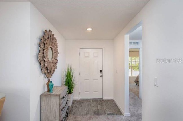 foyer entrance with light colored carpet