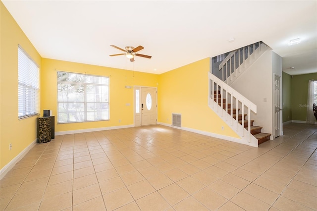 unfurnished living room featuring light tile patterned flooring and ceiling fan