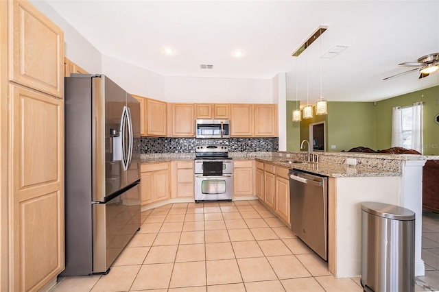 kitchen with sink, light brown cabinets, kitchen peninsula, and appliances with stainless steel finishes