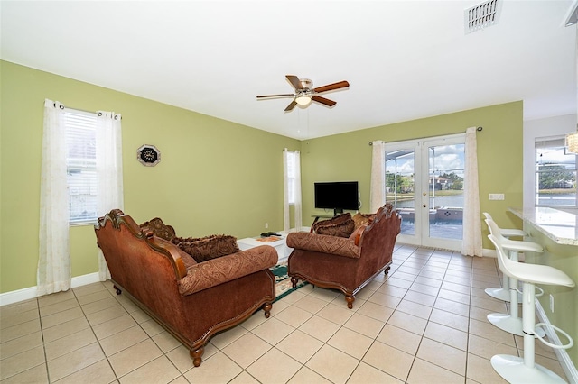 living room featuring french doors, ceiling fan, and light tile patterned floors