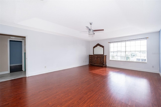 unfurnished living room featuring ceiling fan and dark hardwood / wood-style floors