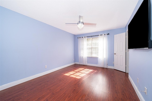 spare room featuring ceiling fan and dark hardwood / wood-style flooring