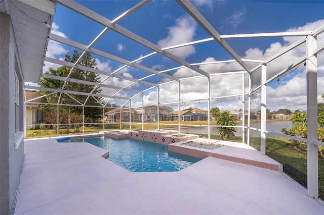 view of pool with a patio area, a water view, and glass enclosure