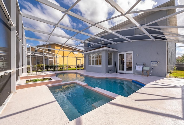 view of swimming pool with an in ground hot tub, a lanai, a patio, and french doors