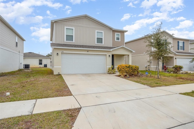 view of front facade with a front yard, cooling unit, and a garage