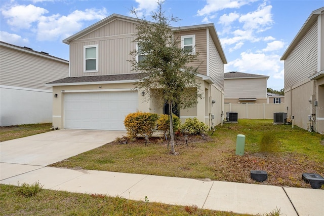 view of front of house featuring a front yard, a garage, and central AC